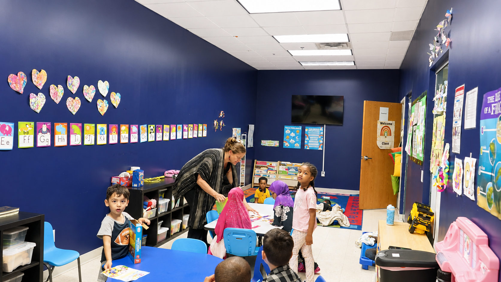 Preschool teacher engaging with children during an activity