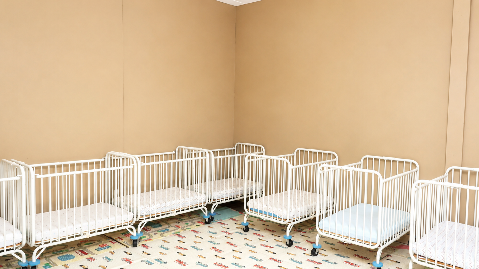 Peaceful infant room with cribs ready for nap time